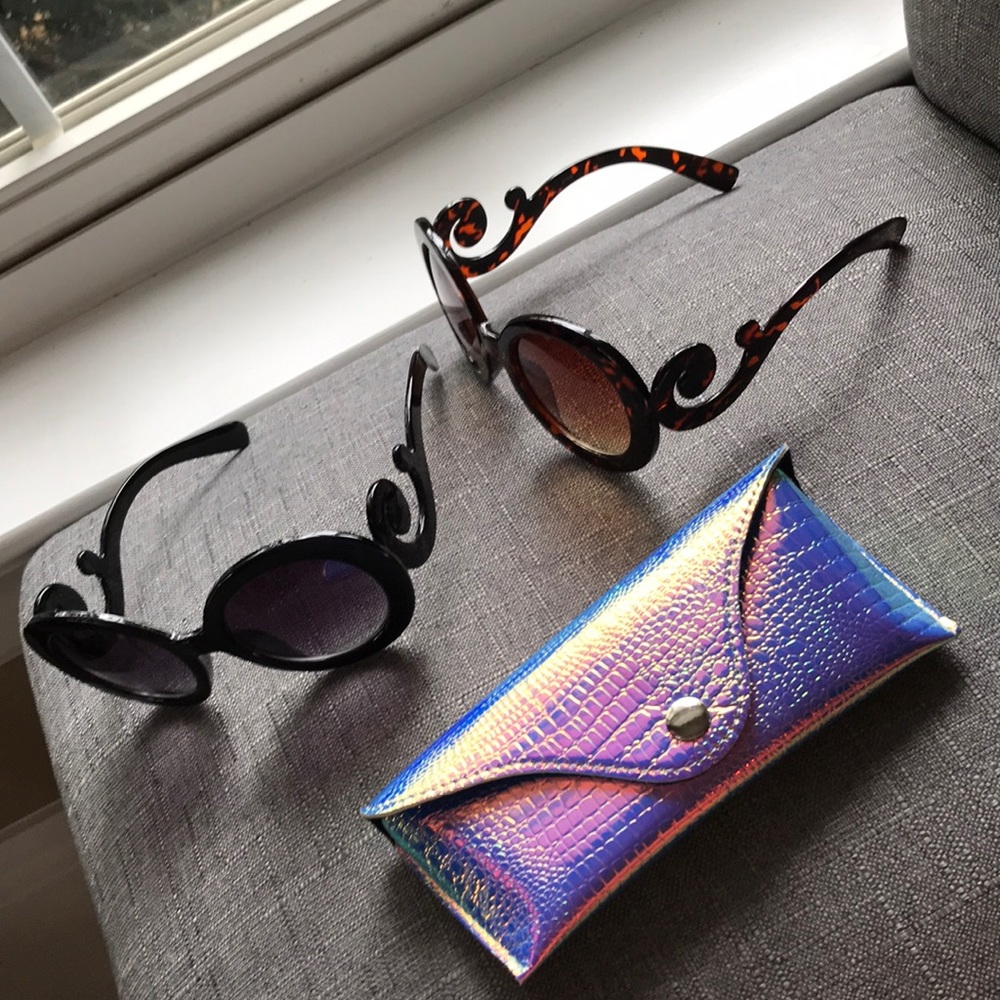 2 sunglasses and 1 sunglasses holder
